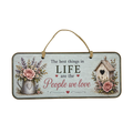 A rectangular hanging wall sign with a rustic distressed light blue-gray background. The sign features the text 'The best things in LIFE are the People we love' in black and dusty pink lettering, decorated with illustrations of pink roses in a galvanized metal pitcher on the left and a small wooden birdhouse on the right.