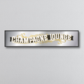 Decorative mirror sign with 'Champagne Lounge' art deco style text on a light gray background