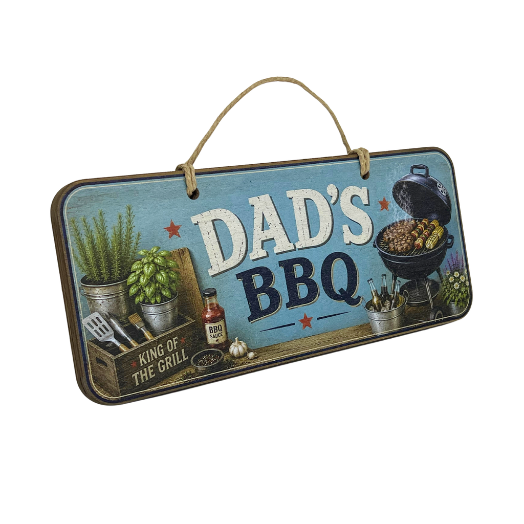 A rectangular hanging wooden sign with a rustic blue background and the words “DAD'S BBQ” in large white and dark lettering. The sign includes barbecue-themed illustrations such as a grill, plants, utensils, and a bottle, with a rope handle at the top, shown on a plain white background.