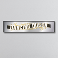 Decorative mirror sign with 'Dancing Queen' art deco style text on a gray background