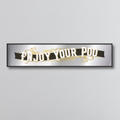 Decorative mirror sign with 'Enjoy Your Poo' art deco style text on a gray background