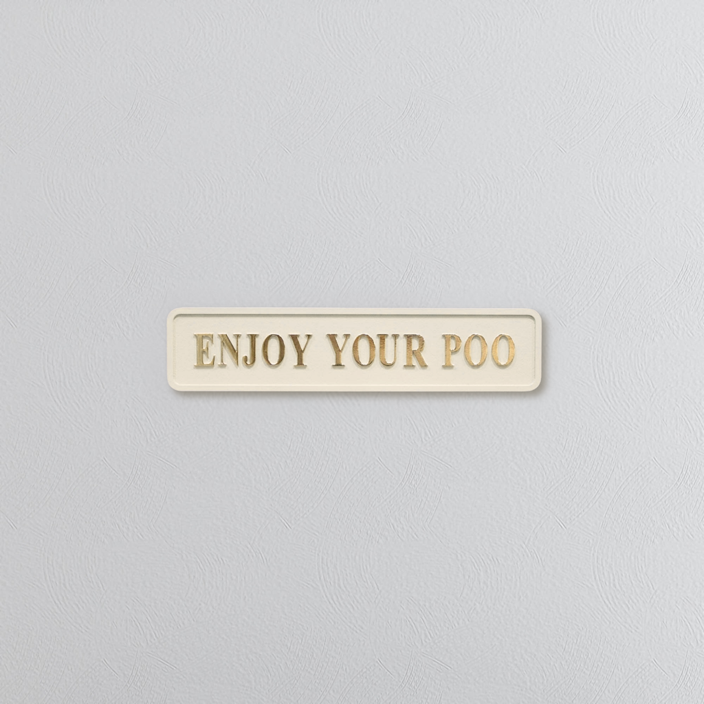 Cream and gold sign saying 'ENJOY YOUR POO'