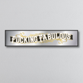 Decorative mirror sign with 'Fucking Fabulous' art deco style text on a gray background