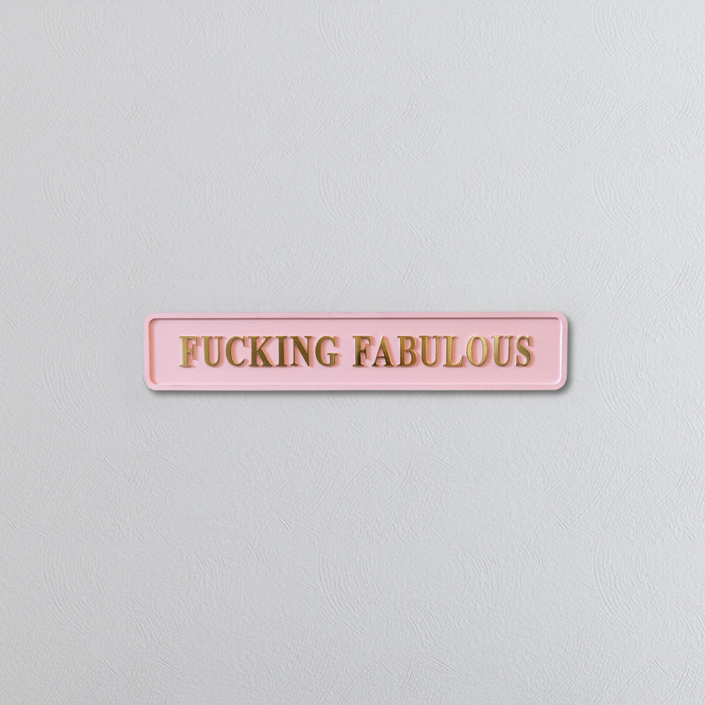 Pink decorative foil sign with gold text saying FUCKING FABULOUS