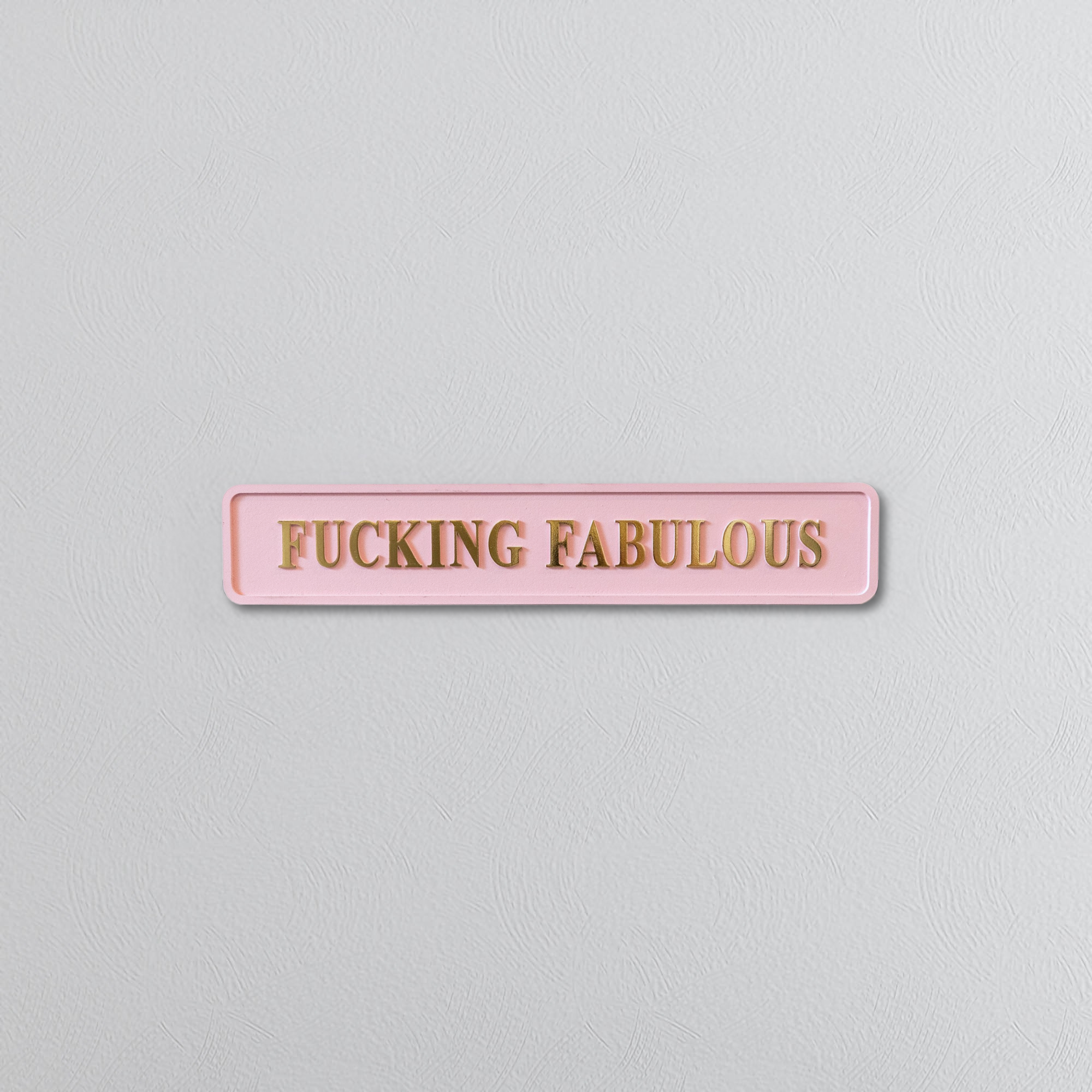 Pink decorative foil sign with gold text saying FUCKING FABULOUS