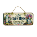 A rectangular hanging wall sign with a natural jute loop at the top. The sign features a vintage-style illustration with the text 'In the GARDEN Sipping Gin' and decorative elements including a gin bottle, a filled cocktail glass, flowers, and a watering can.