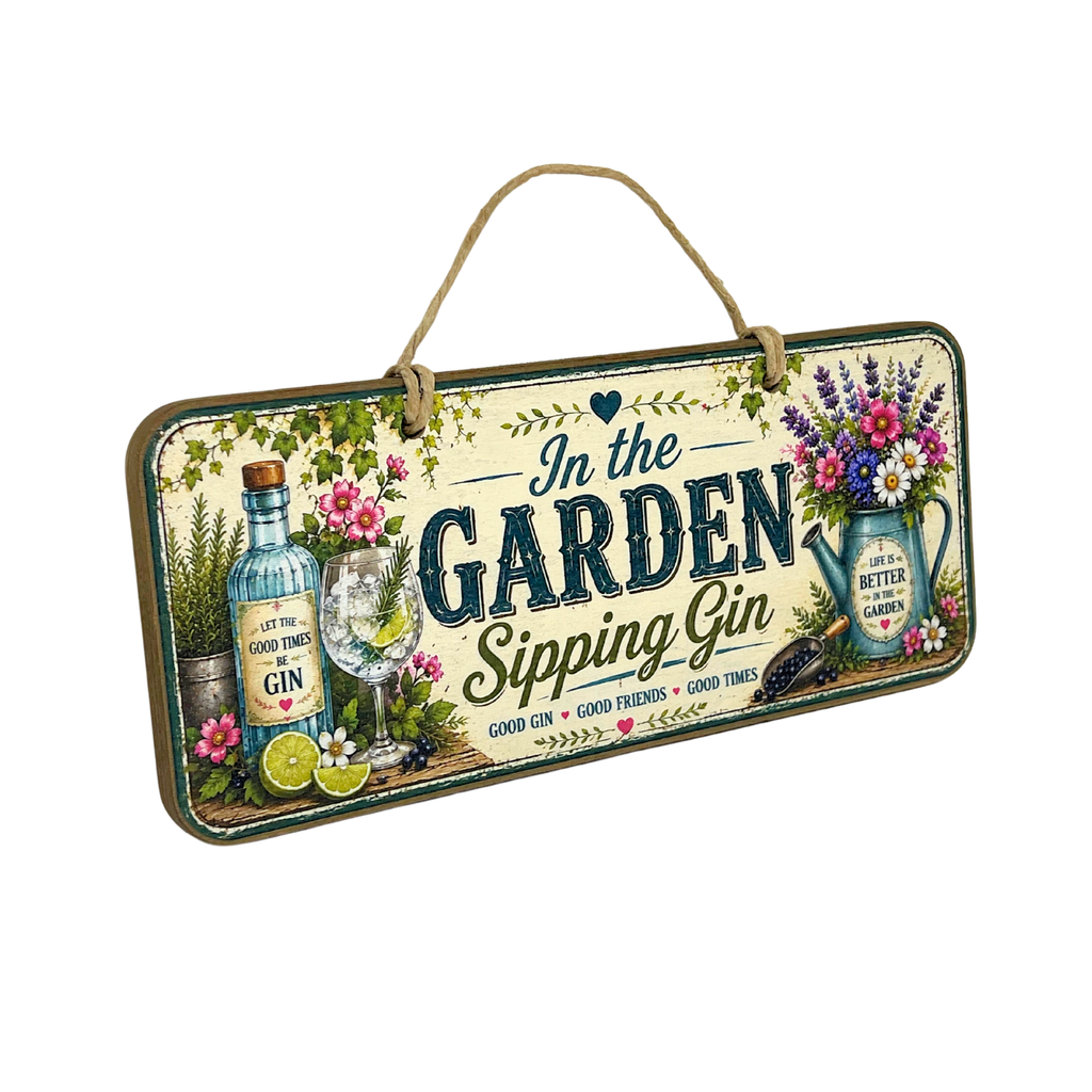 A rectangular hanging wooden sign with a natural jute loop at the top. The sign features a vintage-style illustration of a gin bottle, a filled drinking glass, limes, flowers, and a watering can, with the text 'In the GARDEN Sipping Gin' on a cream background.