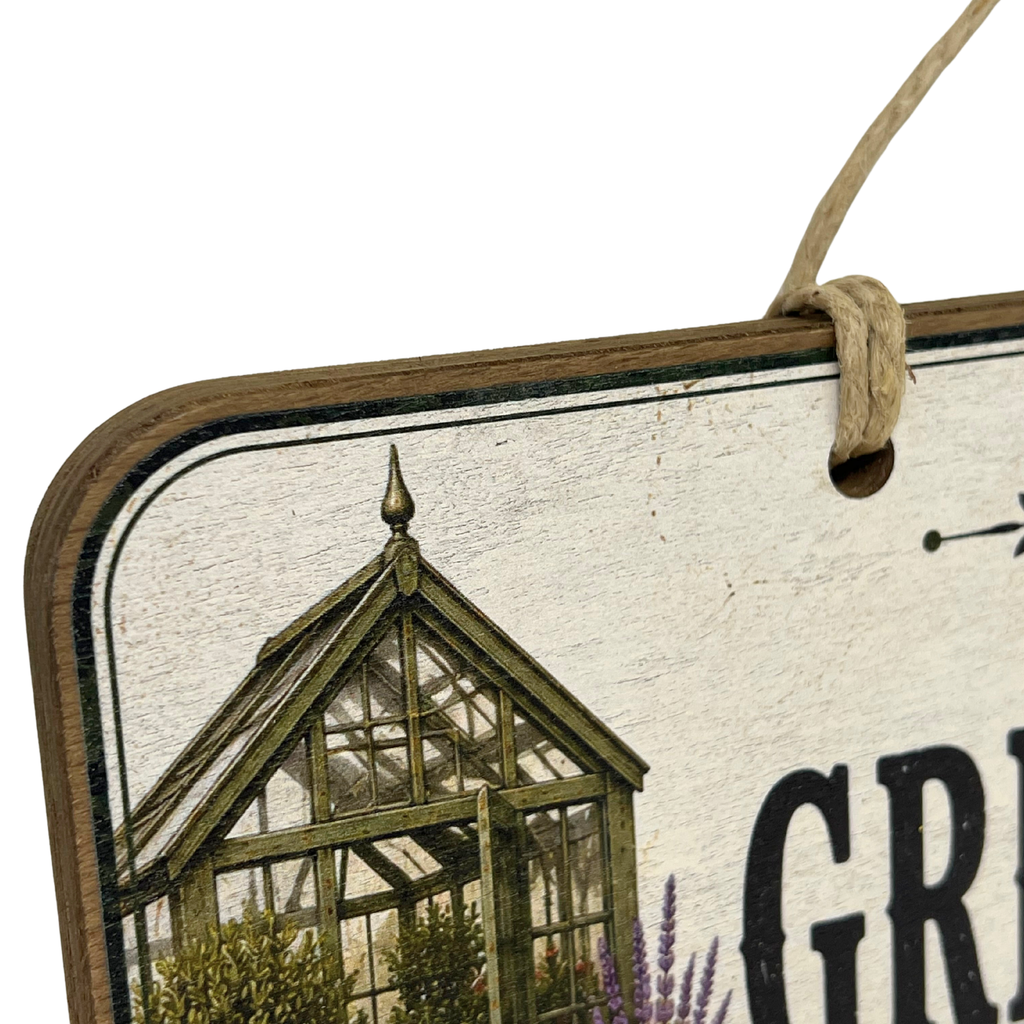 A close-up of a rustic wooden hanging sign with a hanging twine loop, featuring an illustration of a greenhouse and partial black lettering on a distressed off-white background.