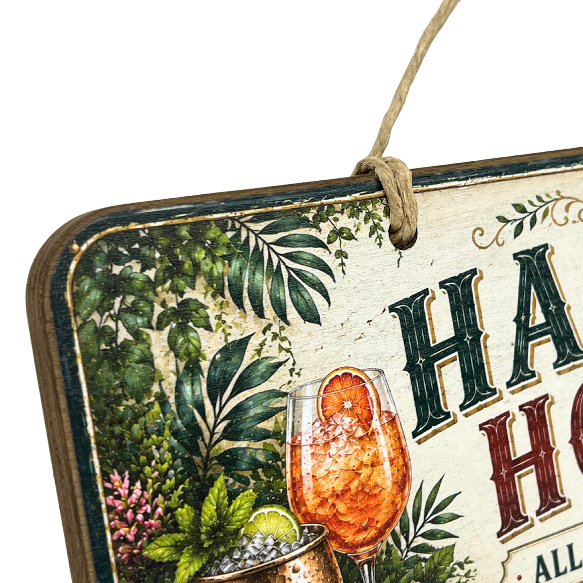 A close-up of a decorative hanging sign with tropical botanical illustrations, a cocktail glass, and partial text reading 'HA.