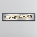 Decorative mirror sign with 'Hello Beautiful' art deco style text on a light gray background