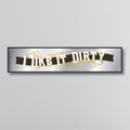 Decorative mirror sign with 'I like it dirty' art deco text on a plain background