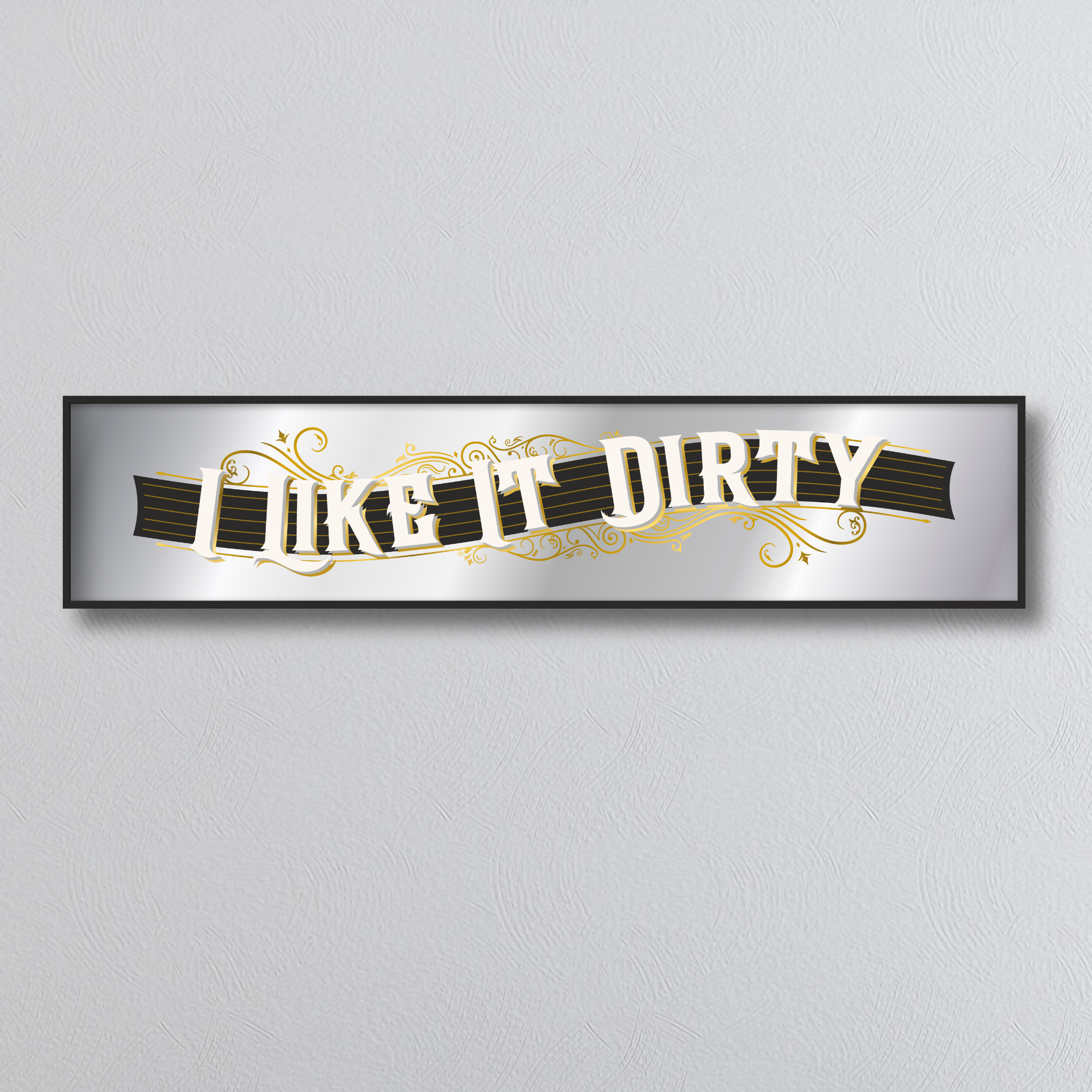 Decorative mirror sign with 'I like it dirty' art deco text on a plain background