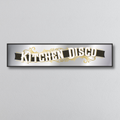 Decorative mirror sign with 'Kitchen Disco' art deco style text on a light gray background