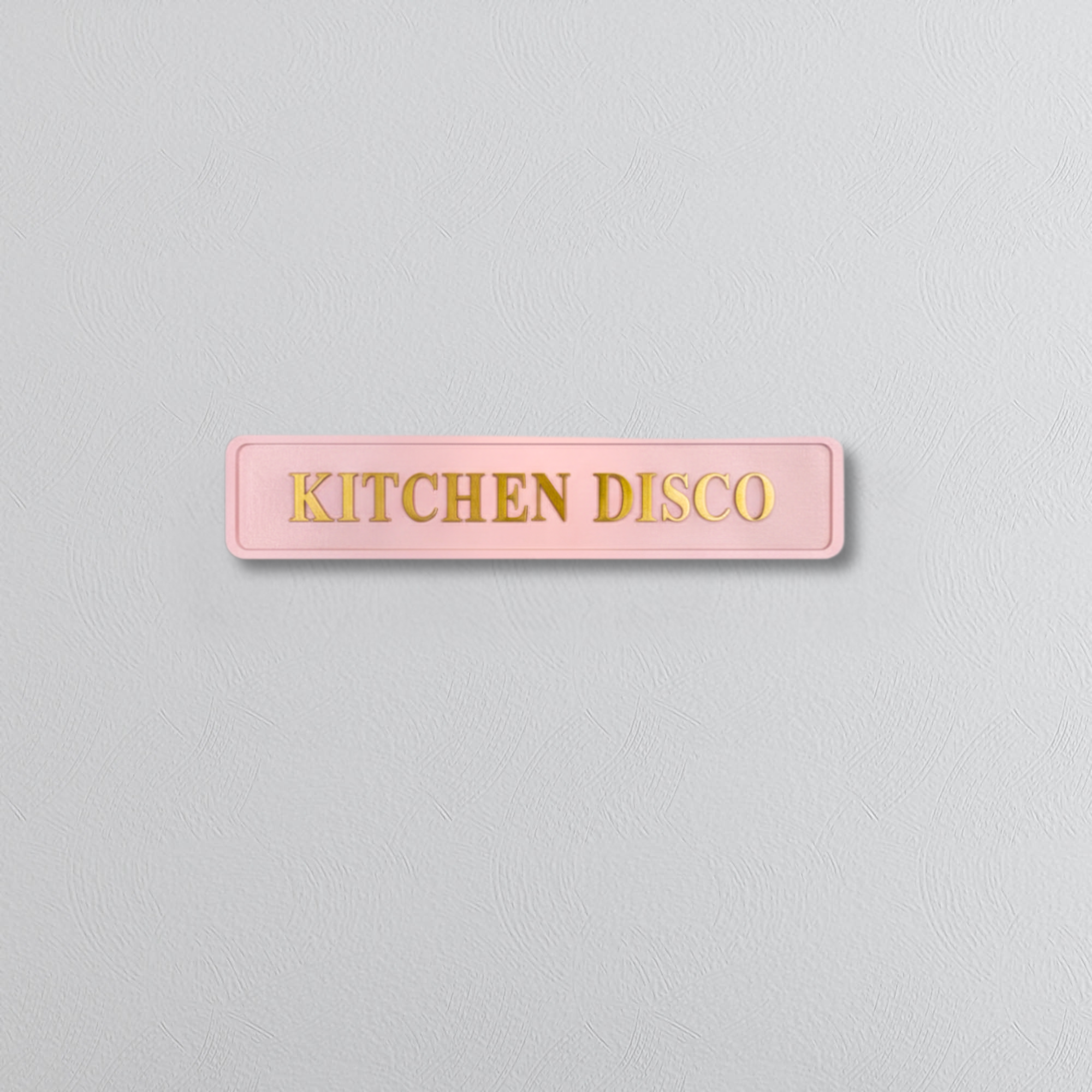 Pink decorative sign with KITCHEN DISCO gold text