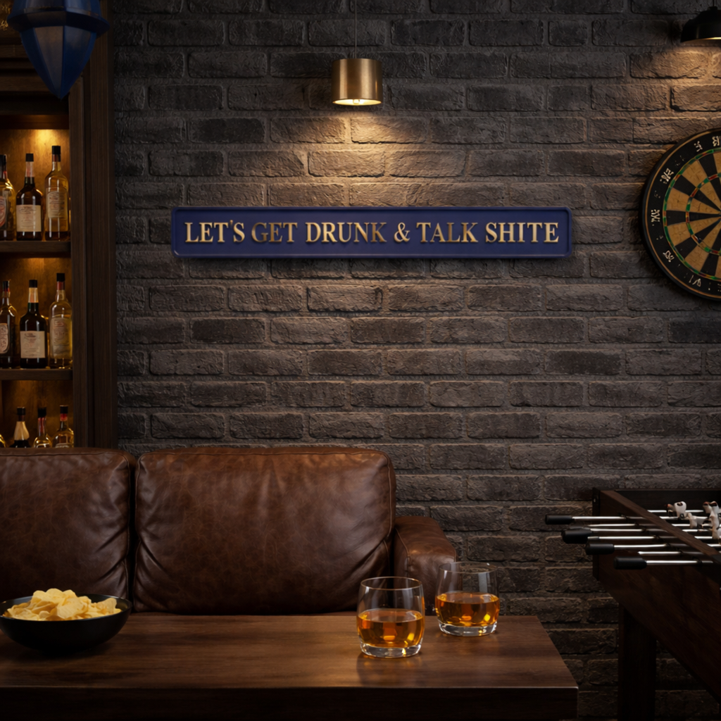 Bar setting with a sign reading 'Let's get drunk & talk shite', two glasses of alcohol, and a dartboard on a brick wall.