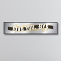 Decorative nirror sign with 'I LOVE YOU. BYE' art deco style text on a gray background