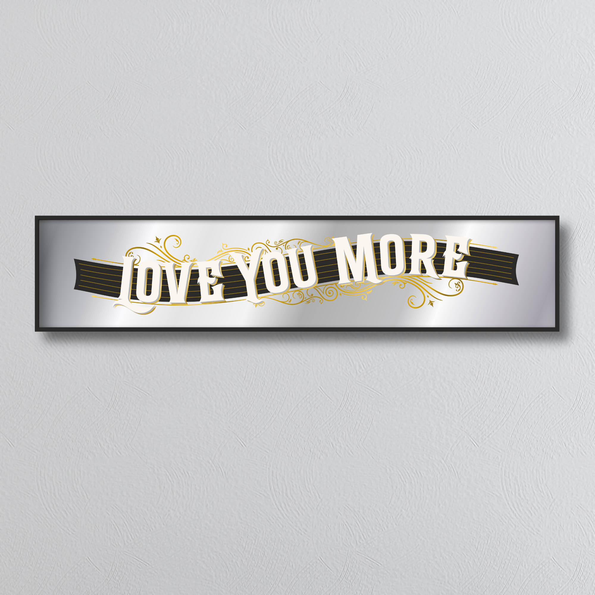 Decorative mirror sign with 'I love you more' art deco style text on a plain background