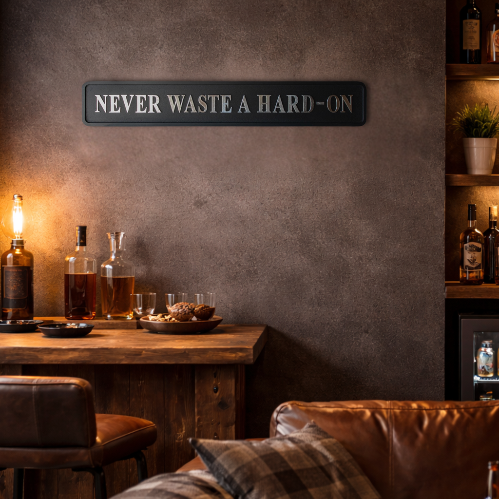 Man cave area with wooden counter, leather chairs, and 'Never Waste a Hard-On' sign on wall.