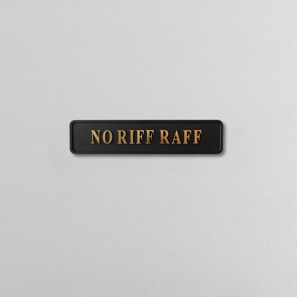 Black decorative sign with NO RIFF RAFF gold text