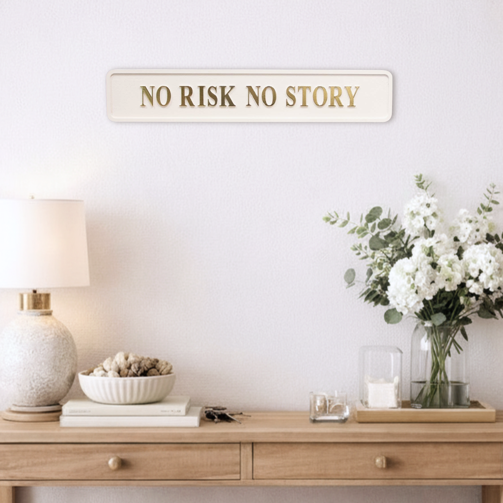 Decorative setup with a 'No Risk No Story' sign on a wall above a wooden console table.
