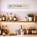 Home bar set up with a 'OH FOR FUCK'S SAKE' sign with gold text