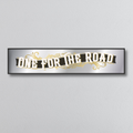 Decorative mirror sign with 'One for the Road' art deco style text on a gray background