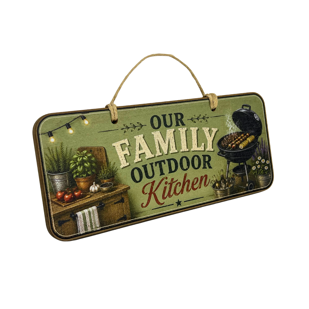 A rectangular hanging decorative sign with a rustic outdoor kitchen theme. The sign features the text 'OUR FAMILY OUTDOOR Kitchen' on a distressed olive green background, with illustrations of a wooden grill, potted herbs, tomatoes, and string lights, and is suspended by a natural jute rope handle.