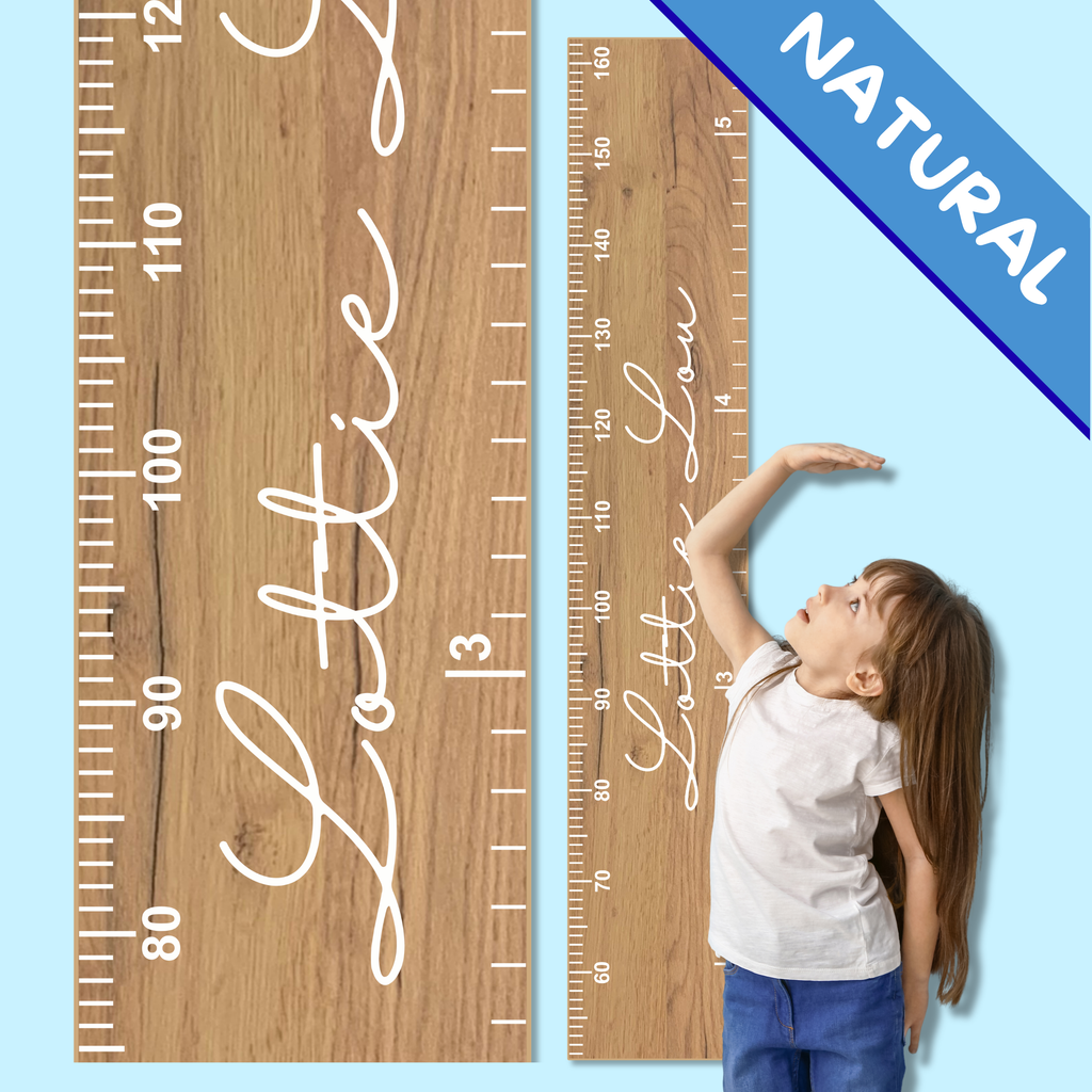 Wooden growth chart with personalised name in cursive font  and a child measuring their height.