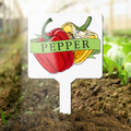 Garden marker with pepper illustration and text in a garden setting