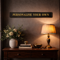 Decorative setup with a custom foil sign on the wall with 'Personalise Your Own' in gold text.