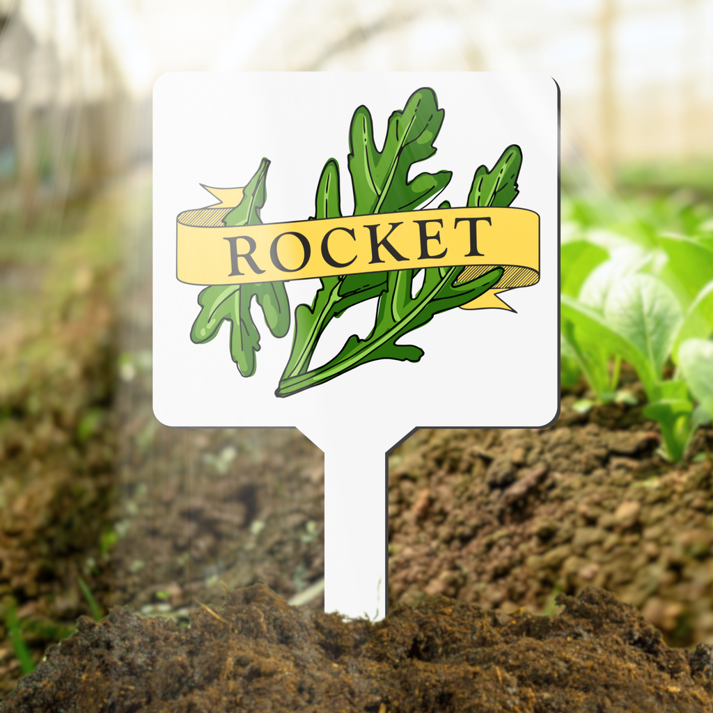 Plant marker with rocket illustration and label in a garden setting