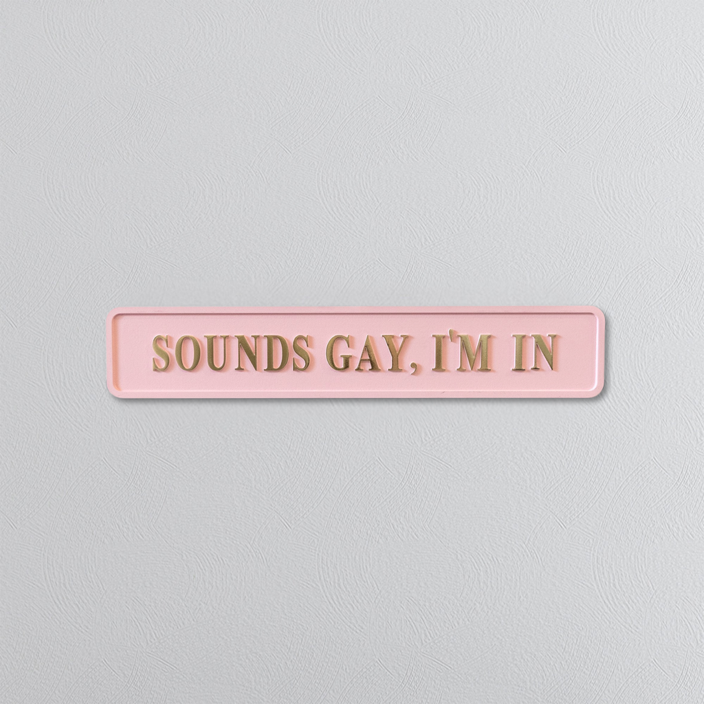Pink sign with gold text 'SOUNDS GAY, I'M IN' on a light gray background