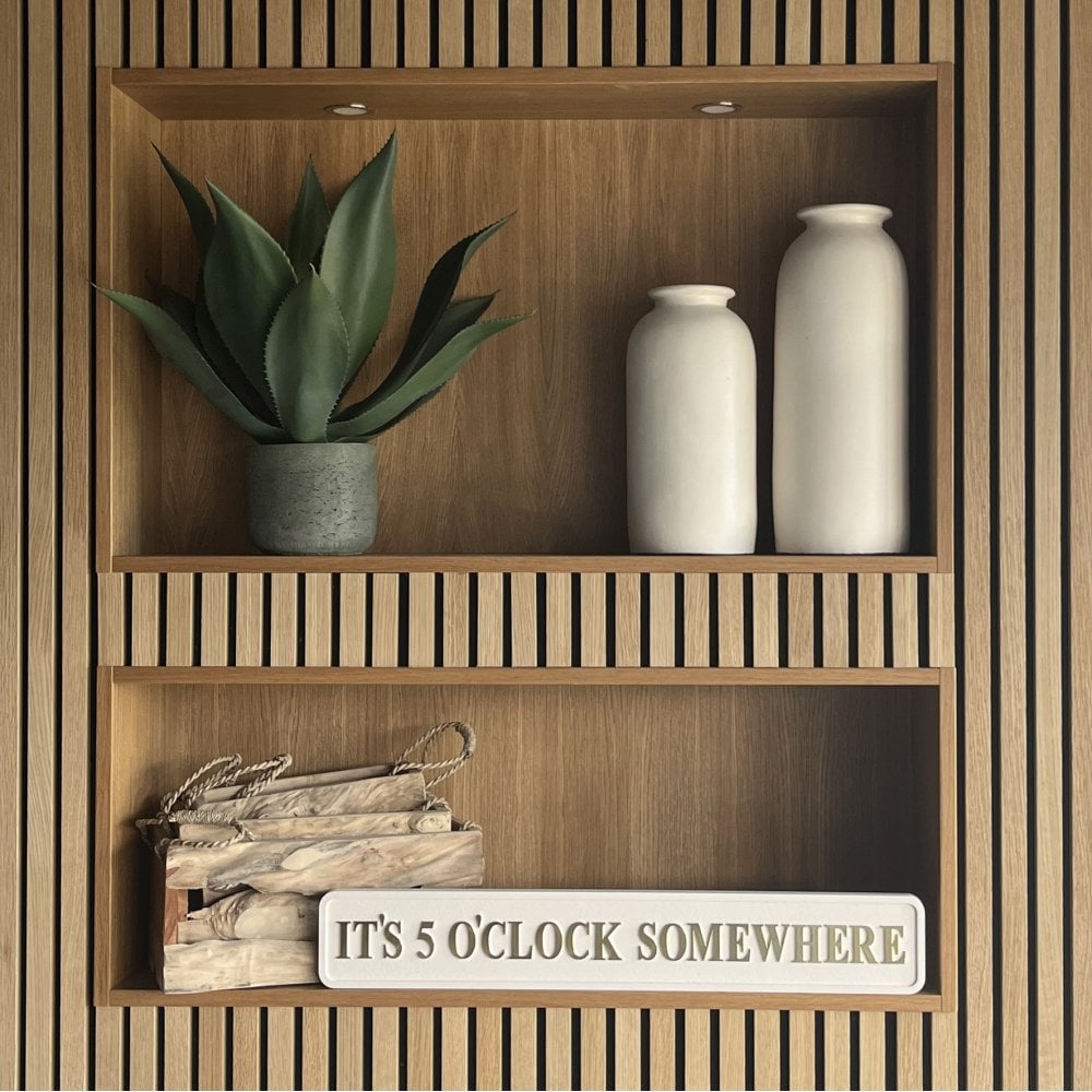 Wooden shelf with decorative items including a plant, vases, and a sign reading 'It's 5 O'Clock Somewhere'.