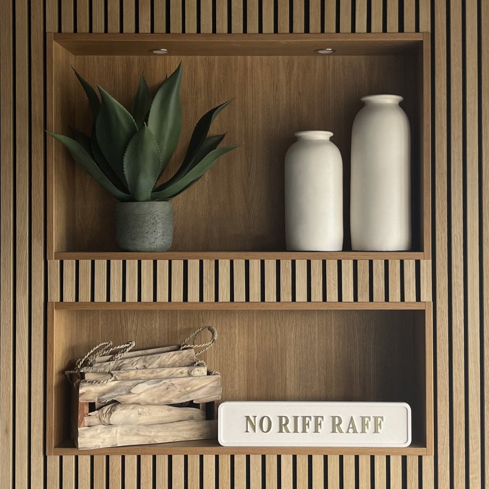 Wooden shelves with decorative items including a plant, vases, and a sign reading NO RIFF RAFF on a wooden wall.