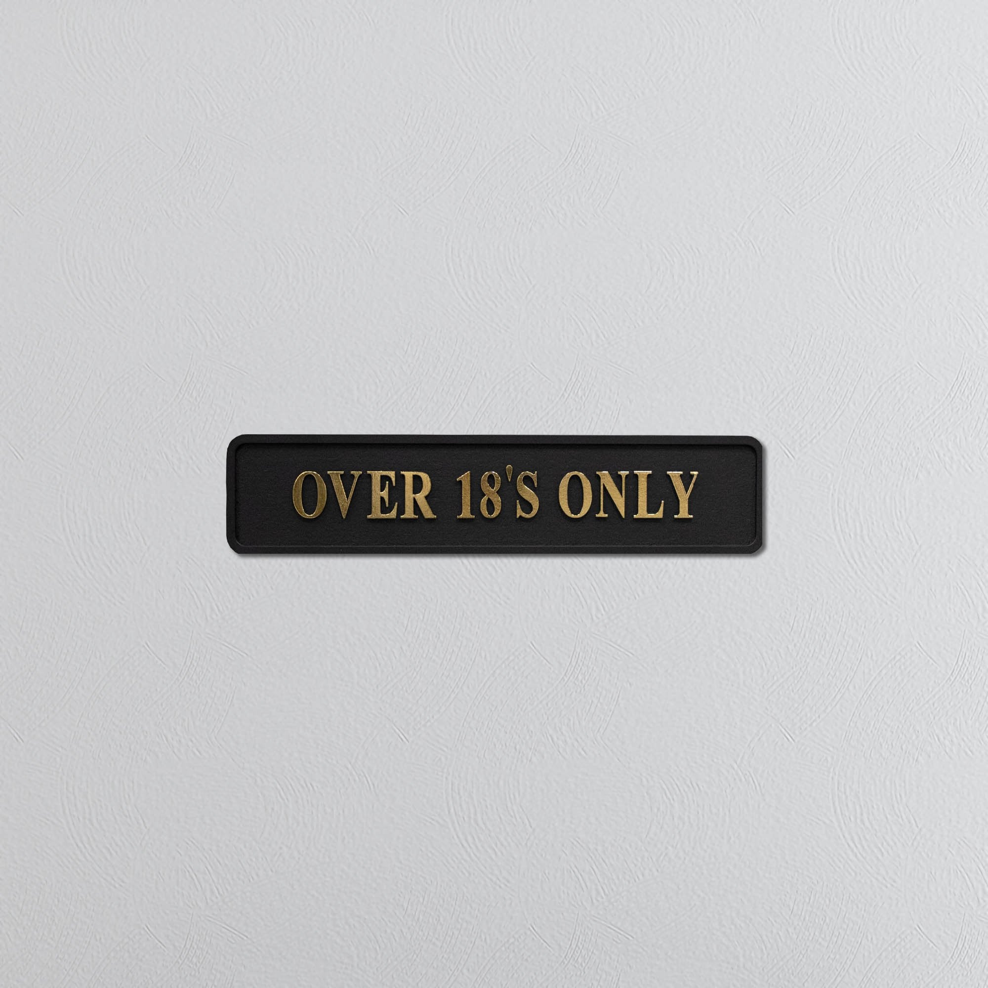 Black sign with 'OVER 18'S ONLY' gold text on a light gray background