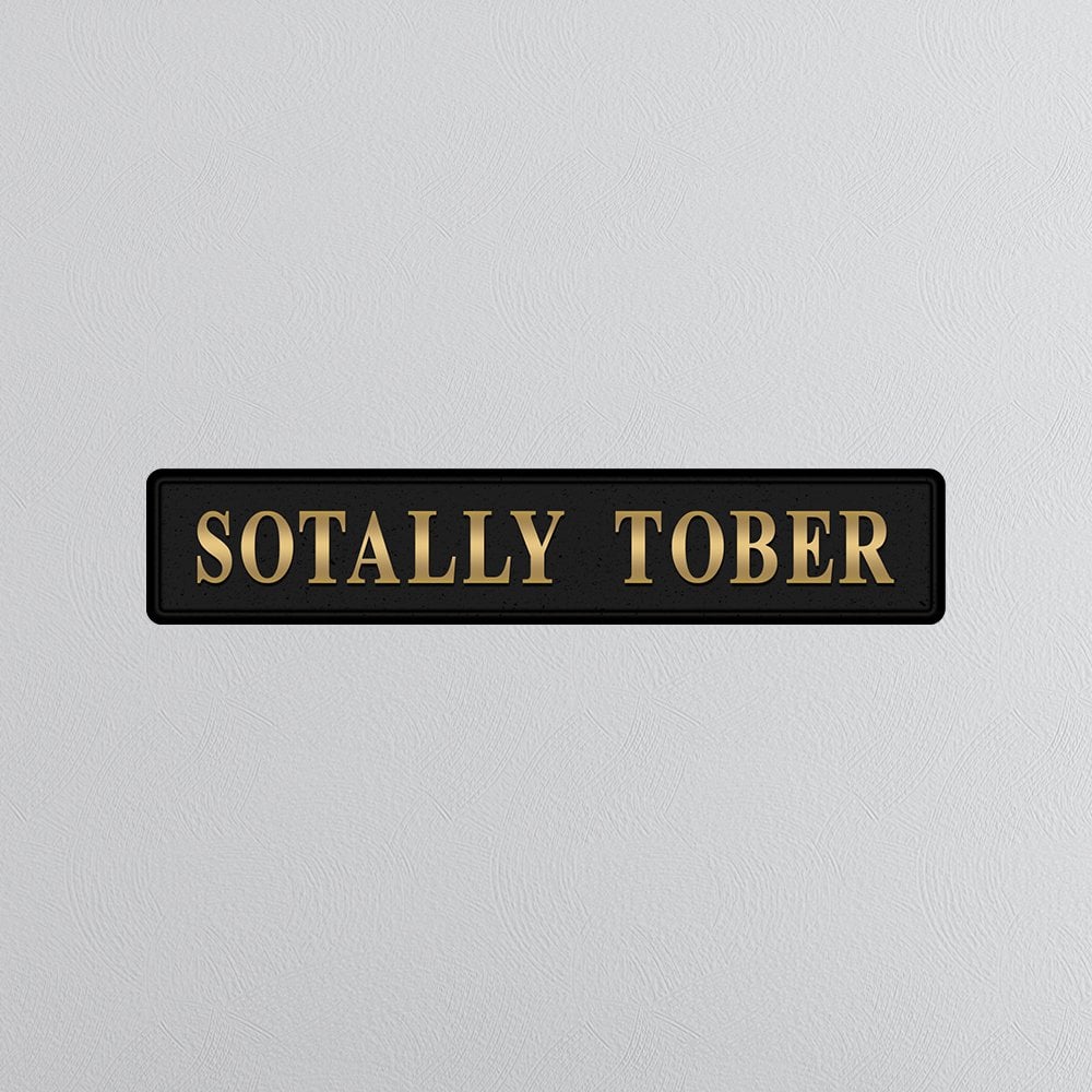 Decorative sign with 'SOTALLY TOBER' text on a light gray background