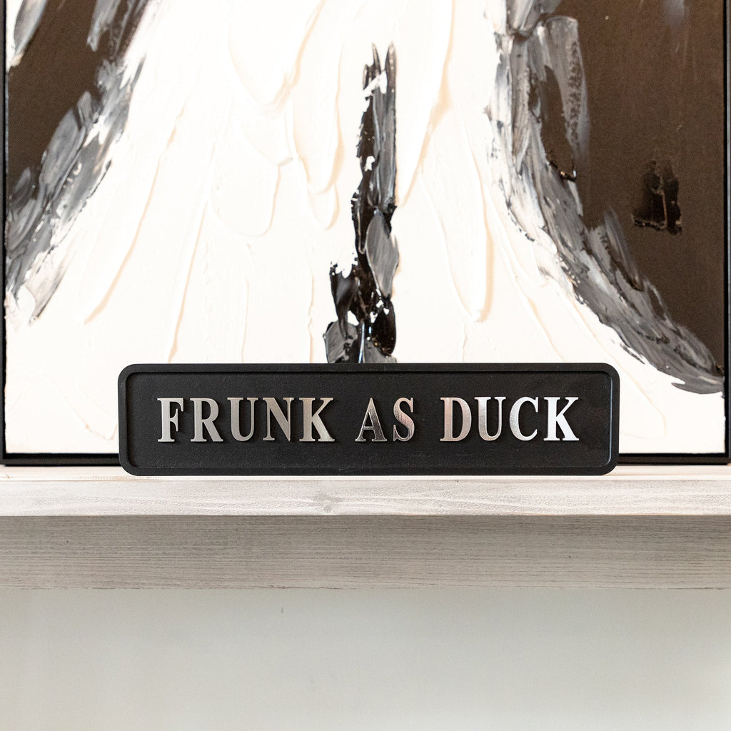 Black and silver foiled street sign with 'Frunk as duck' wording