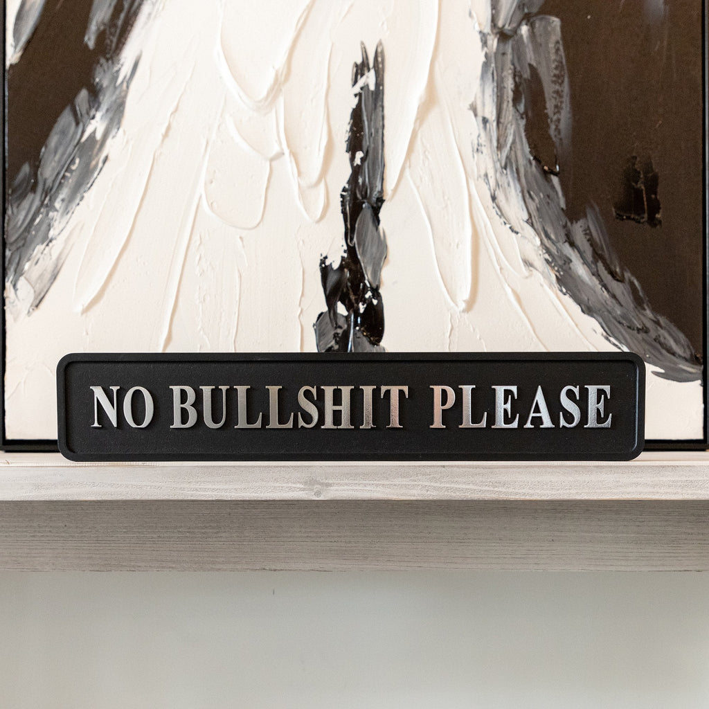 Black and silver foiled street sign with 'No bullshit please' wording