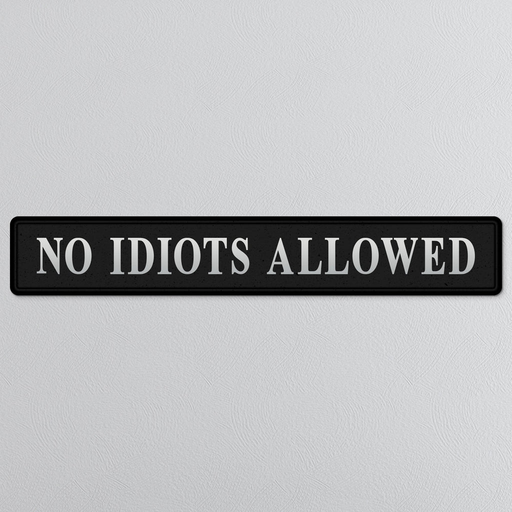 Black and silver foiled street sign with 'No idiots allowed' wording
