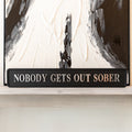 Black and silver foiled street sign with 'Nobody gets out sober' wording