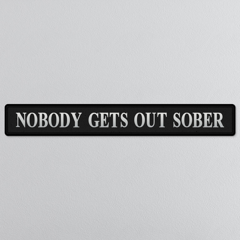 Black and silver foiled street sign with 'Nobody gets out sober' wording