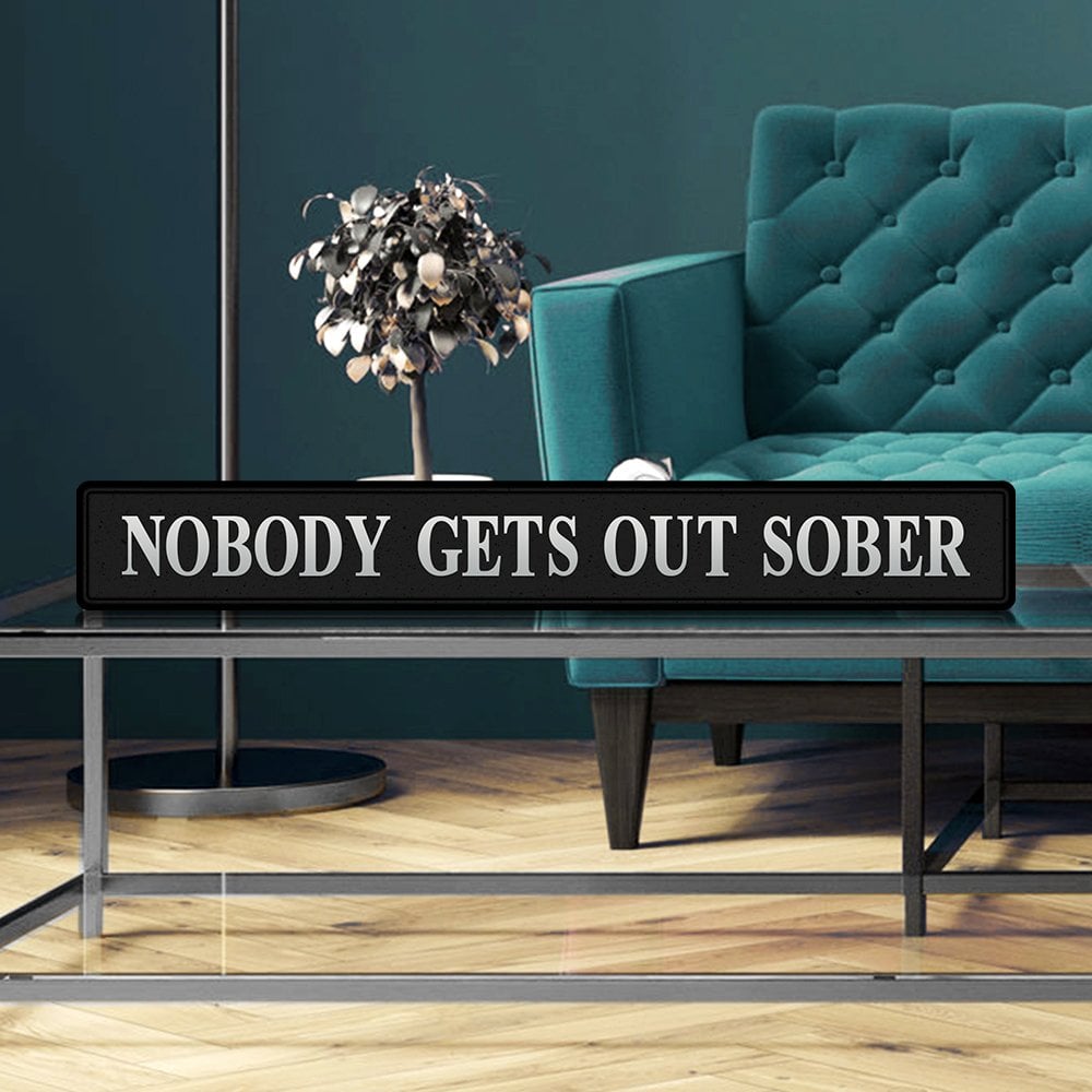 Black and silver foiled street sign with 'Nobody gets out sober' wording