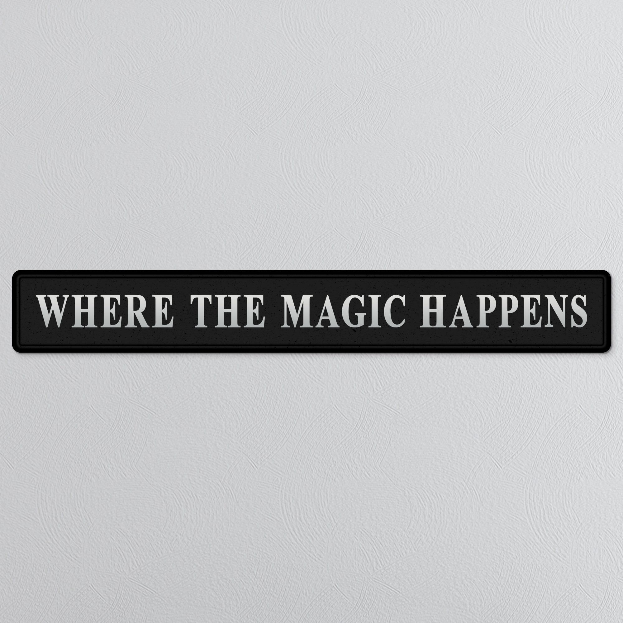 Black and silver foiled street sign with 'Where the magic happens' wording