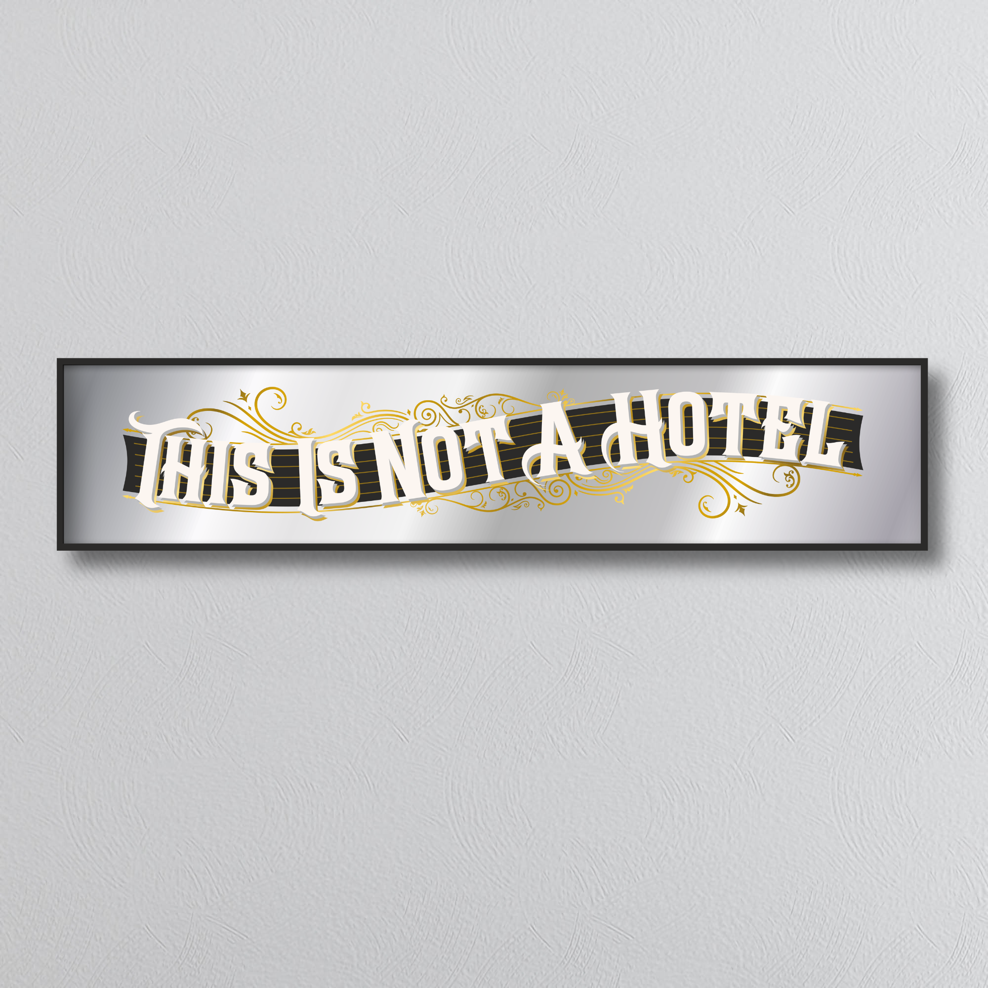 Decorative mirror sign with 'This is not a hotel' art deco style text on a light gray background