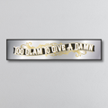 Decorative mirror sign with gold art deco style text 'Too Glam To Give A Damn' on a gray background