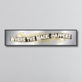 Decorative mirror sign with 'Where the Magic Happens' art deco style text on a plain background