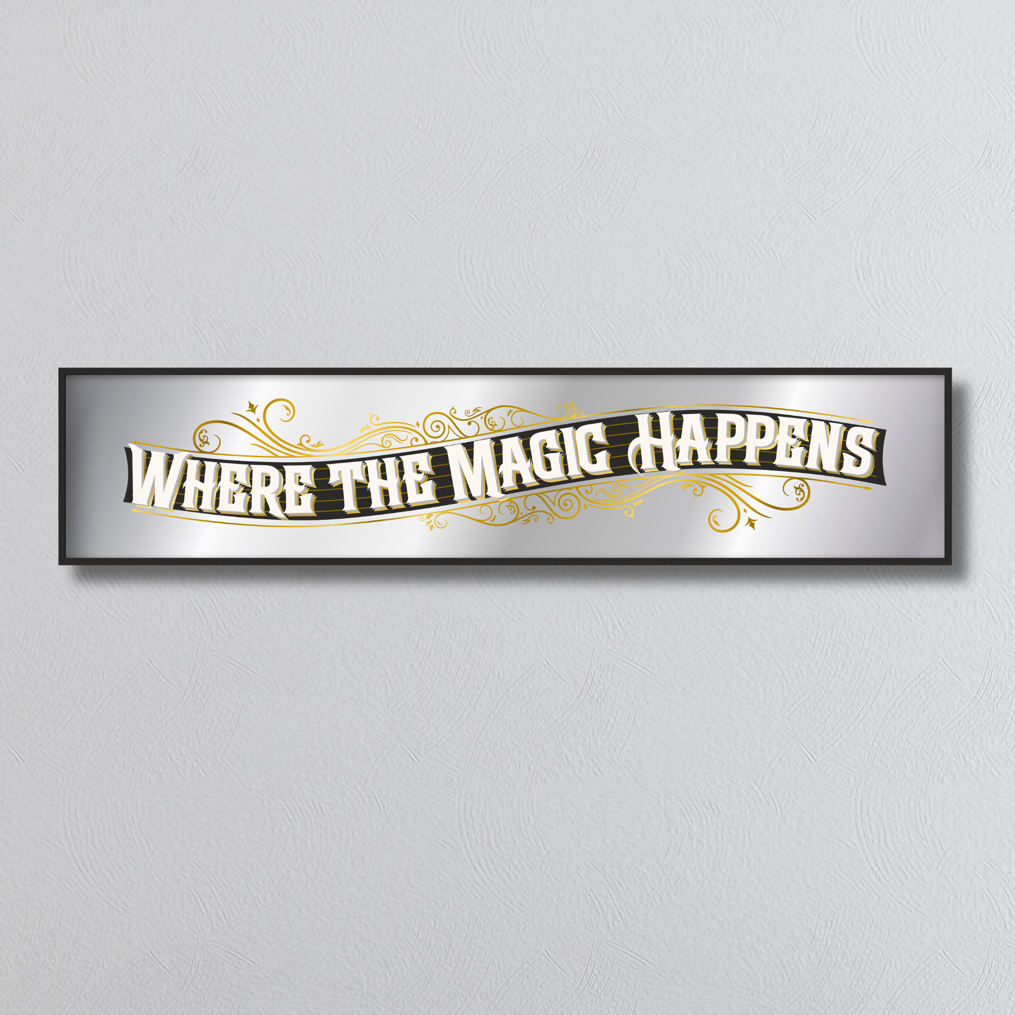 Decorative mirror sign with 'Where the Magic Happens' art deco style text on a plain background