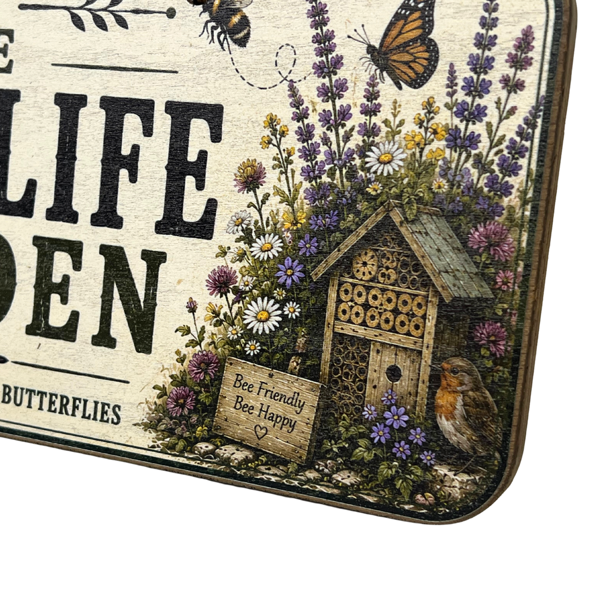 A decorative rectangular sign with rounded corners featuring a vintage-style botanical illustration. The design includes a butterfly, lavender, daisies, a small bee house, a robin, and partial text reading 'LIFE GROWN' and 'BUTTERFLIES.