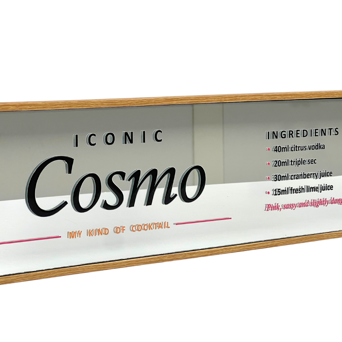 A rectangular bar sign featuring the text 'ICONIC Cosmo' with 'NAVY HONED COCKTAIL' underneath and a list of cocktail ingredients on the right. The sign has a light gray background, black lettering, and a light wood frame, shown against a plain white background.