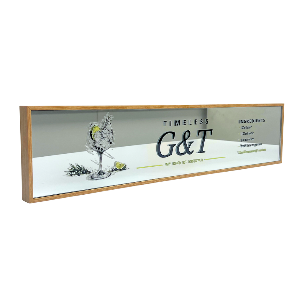 A rectangular framed bar sign with a light wood frame, featuring a printed design with a cocktail glass, lime slices, and the text 'TIMELESS G&T' and 'MY KIND OR YOUR KIND'.